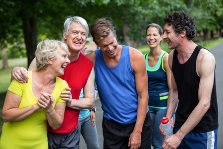 Marathon athletes posing and laughing in parkの写真素材
