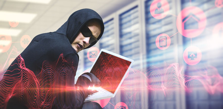 Hacker using laptop to steal identity against abstract blue glowing black background