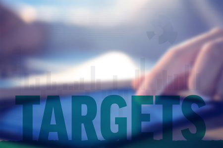 Business interface with graphs and data against businessman using laptop and tablet at deskの写真素材