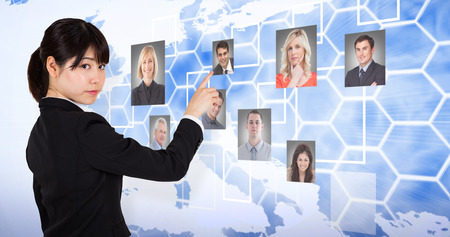 Focused businesswoman pointing against background with europa mapの写真素材