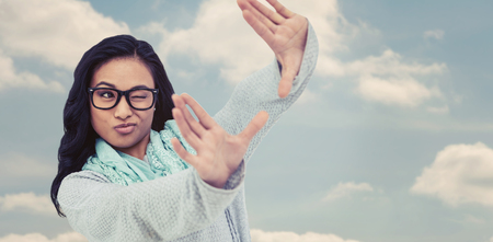 Asian woman making square with hands against beautiful blue cloudy skyの写真素材