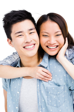 Portrait of young couple smiling on white backgroundの写真素材