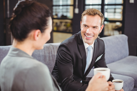 Businessman and businesswoman having a discussion during breaktime in officeの写真素材