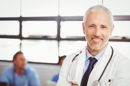 Portrait of happy doctor smiling in conference room in hospitalの写真素材