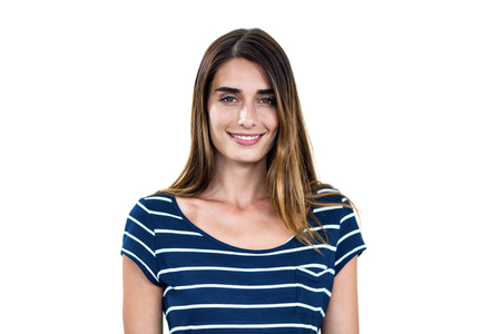 Portrait of smiling young woman standing on white backgroundの写真素材