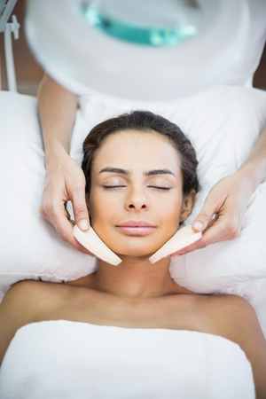 Close-up of woman receiving facial massage at spaの写真素材