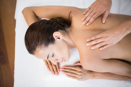 High angle view of beautiful woman receiving back massage at health spaの写真素材