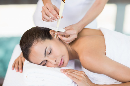 Young woman receiving spa treatment from female masseurの写真素材