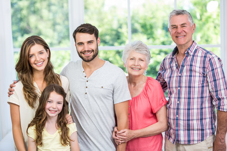 Portrait of happy family standing at home