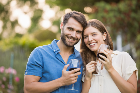 Portrait of couple with wine at parkの写真素材