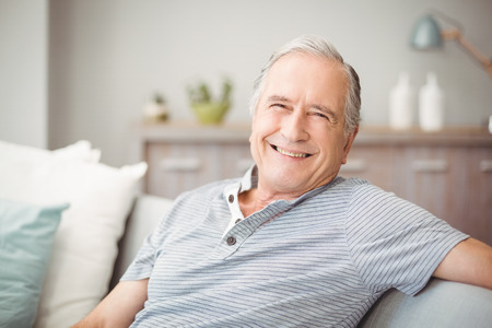 Portrait of happy senior man smiling at home