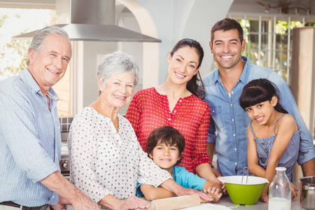 Happy multigeneration family in kitchen at homeの写真素材
