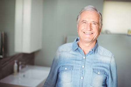 Portrait of smiling senior man in bathroomの写真素材