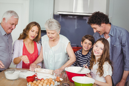 Happy family preparing food in kitchen at home