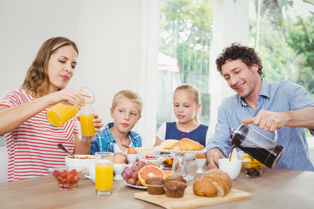 Parents having breakfast with son and daughter at homeの写真素材