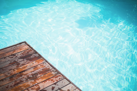 Close-up of wooden deck near swimming poolの写真素材