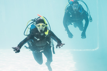 Couple on scuba training in swimming poolの写真素材