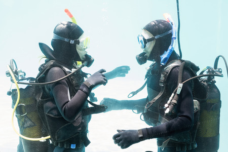 Couple on scuba training in swimming poolの写真素材