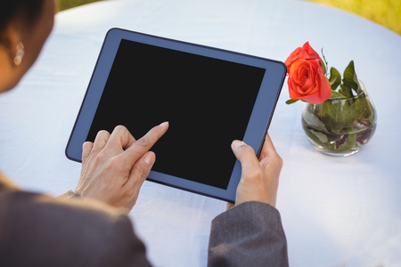 Businesswoman using tablet in a restaurantの写真素材