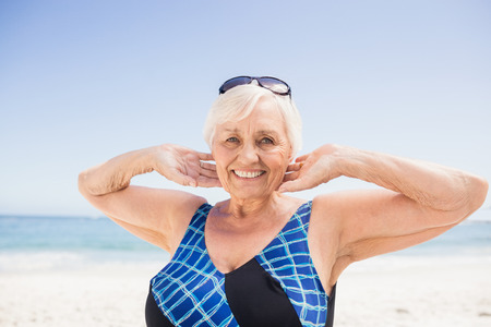 Portrait of smiling senior woman on the beachの写真素材