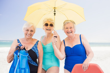 Portrait of senior woman friends on the beachの写真素材