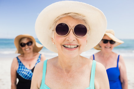 Portrait of senior woman friends on the beachの写真素材