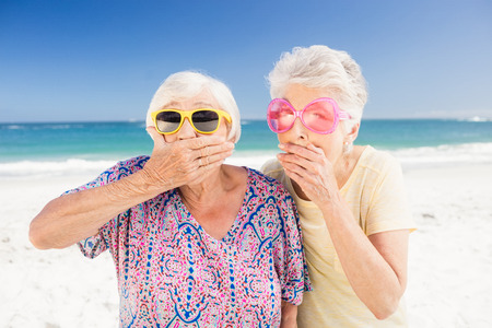 Portrait of surprised senior woman on the beachの写真素材