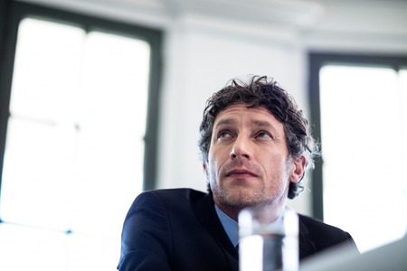 Close-up of thoughtful businessman sitting in restaurantの写真素材