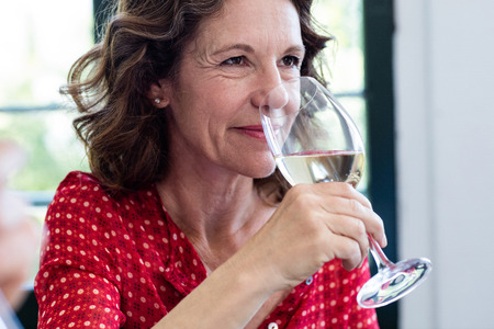 Close-up of woman having wine in a restaurant