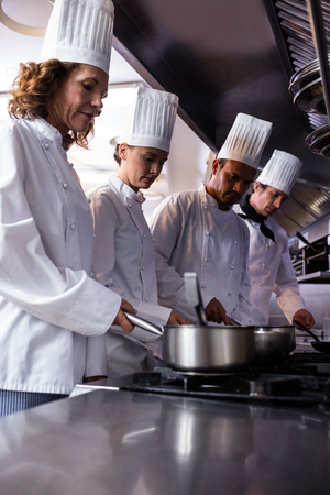 Chefs preparing food in restaurant kitchenの写真素材
