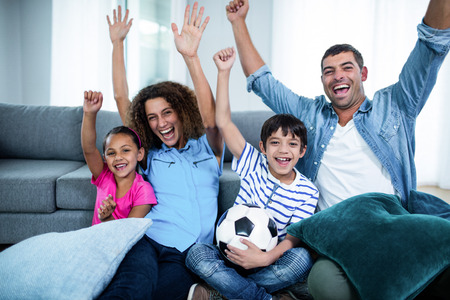 Family watching match on television at homeの写真素材