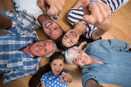 Happy family lying on wooden floor at home