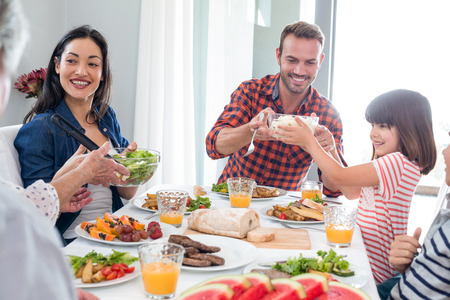 Happy family having breakfast in the morningの写真素材