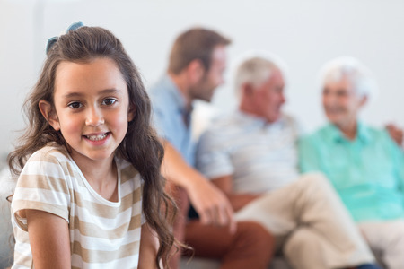 Portrait of innocent girl sitting in the living room at home