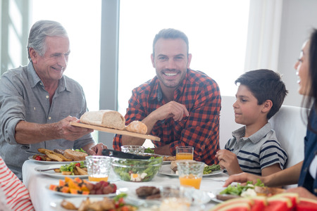 Happy family having breakfast in the morningの写真素材