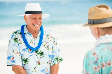 Senior men standing at the beach on a sunny dayの写真素材