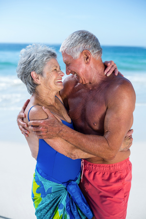 Cute mature couple hugging on the beach on a sunny dayの写真素材