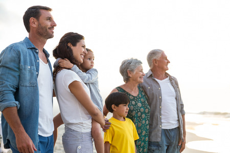 Happy family posing at the beach on a sunny dayの写真素材