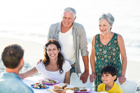 Happy family having a picnic at the beach on a sunny day
