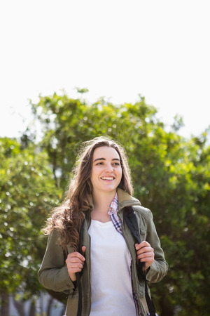 Smiling woman with backpack in the countrysideの写真素材