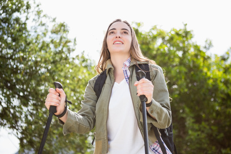 Smiling woman nordic walking in the countrysideの写真素材