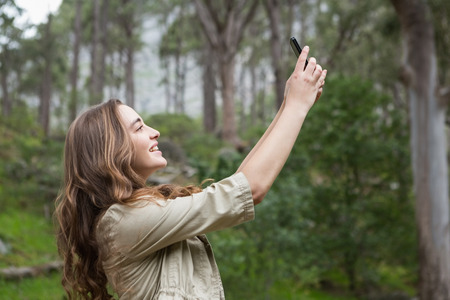 Woman taking selfies in the countrysideの写真素材