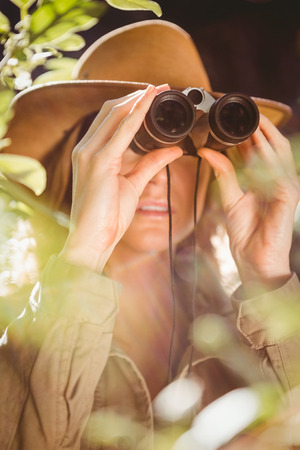 Woman using binoculars in the countrysideの写真素材