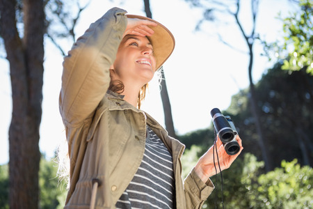 Woman using binoculars in the countrysideの写真素材