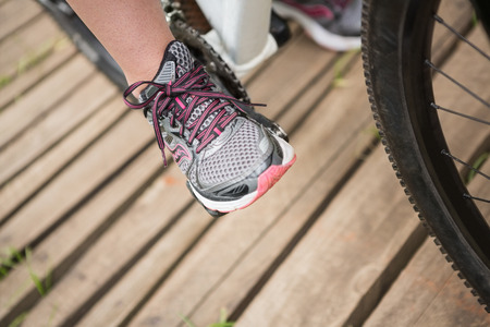 Close-up of woman cycling in the countrysideの写真素材