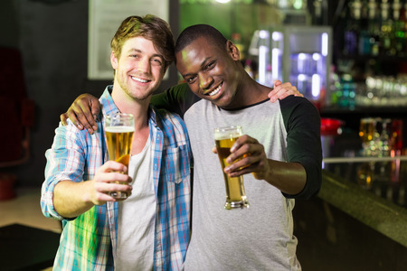 Happy friends having a drink in a barの写真素材