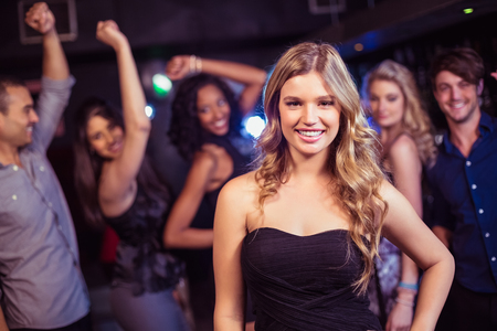 Portrait of smiling blonde woman in a nightclubの写真素材