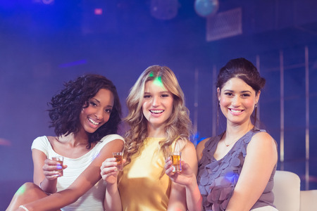 Pretty girls celebrating in a nightclubの写真素材