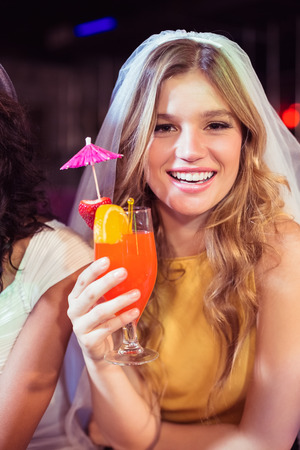 Pretty girl with cocktail in a clubの写真素材