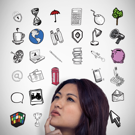 Thoughtful Asian woman with finger on chin against grey vignette